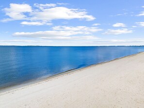 A beach with a clear sky and calm sea. - Beach and Pool Games+PaddleBoard+Bikes (Port St. Joe)
