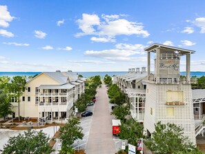 A beachfront hotel with multiple-story buildings, a central walkway, and a view of the sea. - Beach and Pool Games+PaddleBoard+Bikes (Port St. Joe)