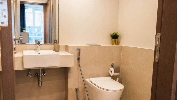 A bathroom with a sink, toilet, and shower. - 1BR in a Landmark Tower  Rooftop Pool, 360° Views, Near Metro (Dubai)