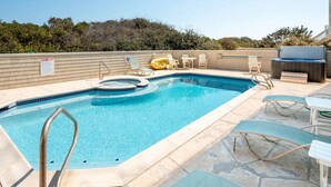 A rectangular outdoor swimming pool with a hot tub, surrounded by lounge chairs and a barbecue area. - RARE Short-term rental on Exclusive Pine Island! Oceanfront&Pool, Oct 8-11, 2026 (Corolla)