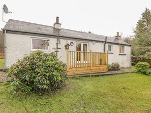A single-story house with a fenced porch, a satellite dish, and a chimney. - The Sheiling (Callander)