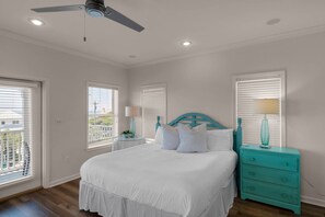 A bedroom with a bed, a ceiling fan, a nightstand, a lamp, and a dresser. - 🌊Seabreeze 30A | Beach Across Street | Bikes | Community Pool (Inlet Beach)