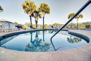 A swimming pool with clear water, surrounded by lounge chairs and palm trees. - 🌊Seabreeze 30A | Beach Across Street | Bikes | Community Pool (Inlet Beach)