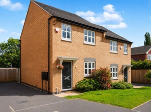 A two-story brick house with a black front door, white windows, and a small front garden. - Arnold 3-bed House, Sleeps 5 With Garden & Parking (Nottingham)