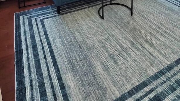 A living room with a blue sofa, a round coffee table, and a ceiling fan. - Sunlit One Bedroom In Allentown (Buffalo)