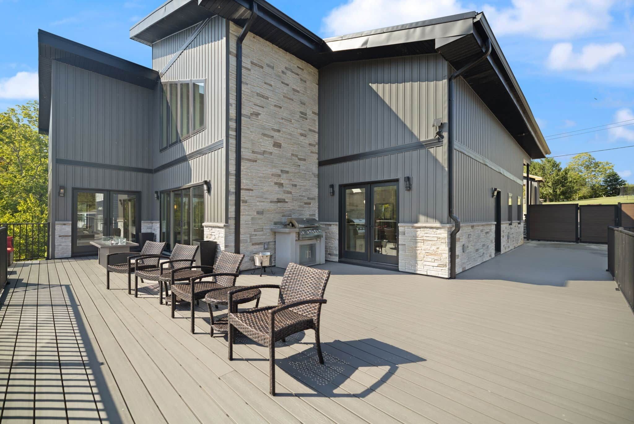 A modern building with a patio area featuring outdoor seating.