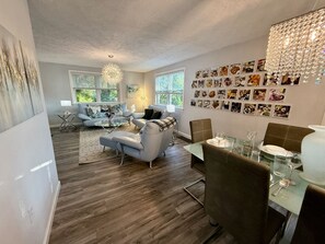 A modern living room with a dining area, wooden flooring, and a chandelier. - Quiet & near downtown Carnegie (Carnegie)