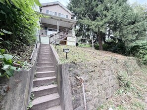 A staircase leading to a building with a sign indicating the number 3202. - Private clean McKees Rocks 2 King bed House (Pittsburgh)