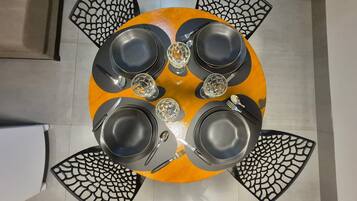 A round table with black chairs, each with a unique cut-out design.