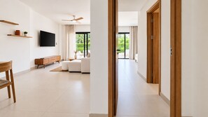 Ein modernes Wohnzimmer mit einer Couch, einem Fernseher und einem Holzschrank.