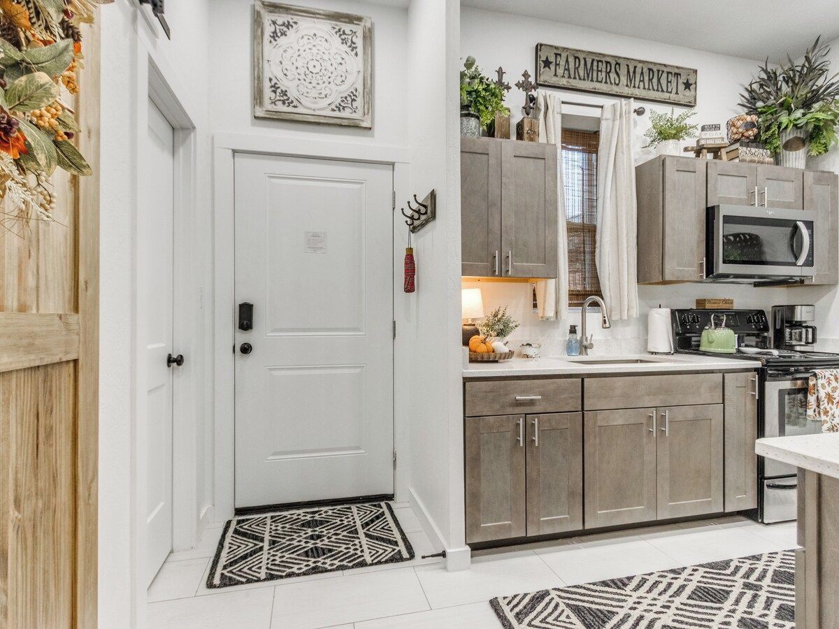 A kitchen with wooden cabinets, a microwave, and a stove.