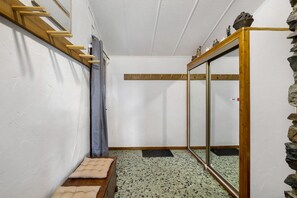A room with a wooden bench, a mirror, a stone wall, and a wooden ceiling. - Peaceful stay in the heart of a mountain village, with views of the pyrenees. (Égat)
