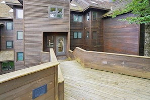 A multi-story wooden building with a wooden deck and a door marked '8-11'. - Your Après Adventure Starts Here E11 (Killington)