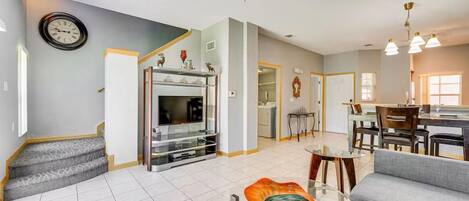 A spacious living area with a fireplace, a dining table, and a sofa.