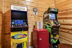 Two arcade machines, one for Pac-Man and another for The Fast and the Furious, in a wooden room. - Abode at Big Pine – Formerly Western Hideaway (Logan)