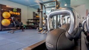 A gym with exercise equipment, including kettlebells and dumbbells. - Sun Shack Cottage | Private Pool Near Disney & Island H2O Access - 8096KD (Kissimmee)