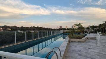 A rooftop swimming pool with a clear view of the city skyline.