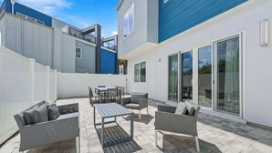A patio area with outdoor furniture, including sofas, a table, and chairs.