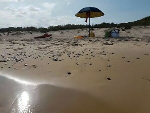 A beach with a sandy shore, a boat, and a beach umbrella. - Visitsicilia Sabbia Dorata (ora n. 497) (Alcamo Marina)