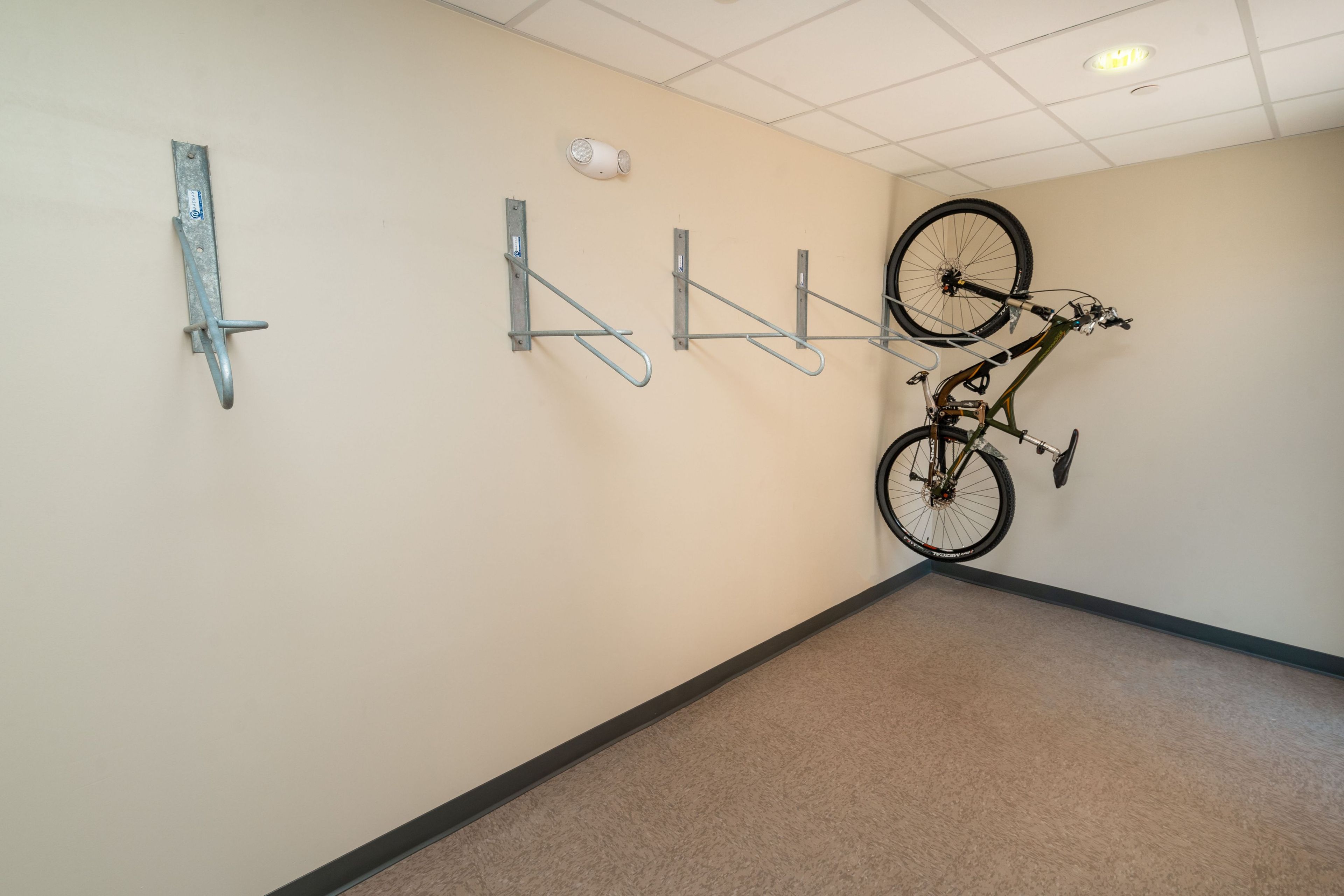 A wall-mounted bike rack with a bicycle.