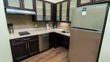 A modern kitchen with dark wood cabinets, stainless steel appliances, and a dishwasher.