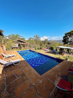 A swimming pool with lounge chairs and a view of the surrounding landscape. - Casa upa con Piscina Climatizada (Barichara)