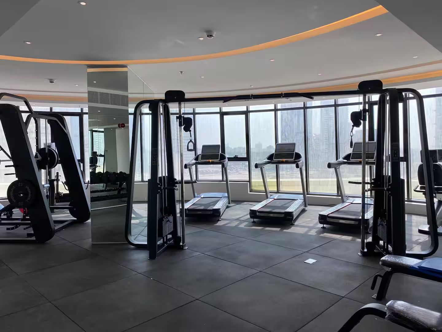 A gym with cardio equipment, weight machines, and treadmills.