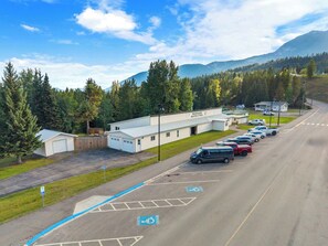 A parking lot with marked handicapped spaces, a building labeled 'Rockwood Health Station,' and a mountainous backdrop.
