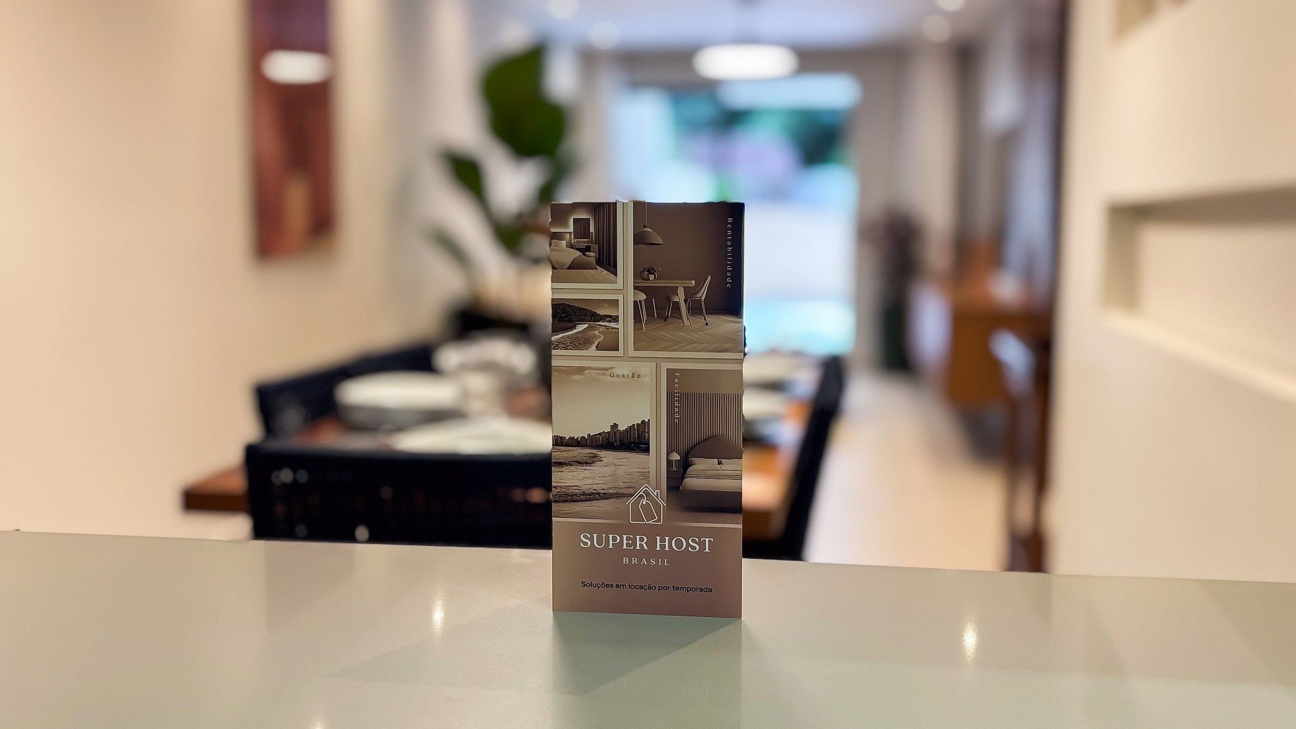 A brochure titled 'SUPERHOST BRASIL' with a cityscape and furniture layout.