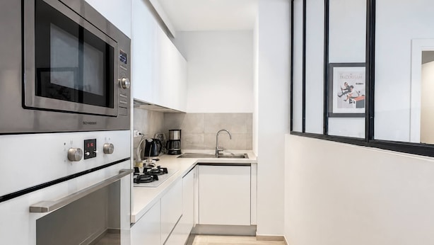 A modern kitchen with stainless steel appliances, a built-in oven, and a sink. - Luxury Apartment, one Bedroom, Prestigious Residence (La Marsa)