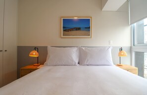 A neatly made bed with white linens in a hotel room. - w* | Charming 1BR w/ Balcony in Miraflores (Miraflores)