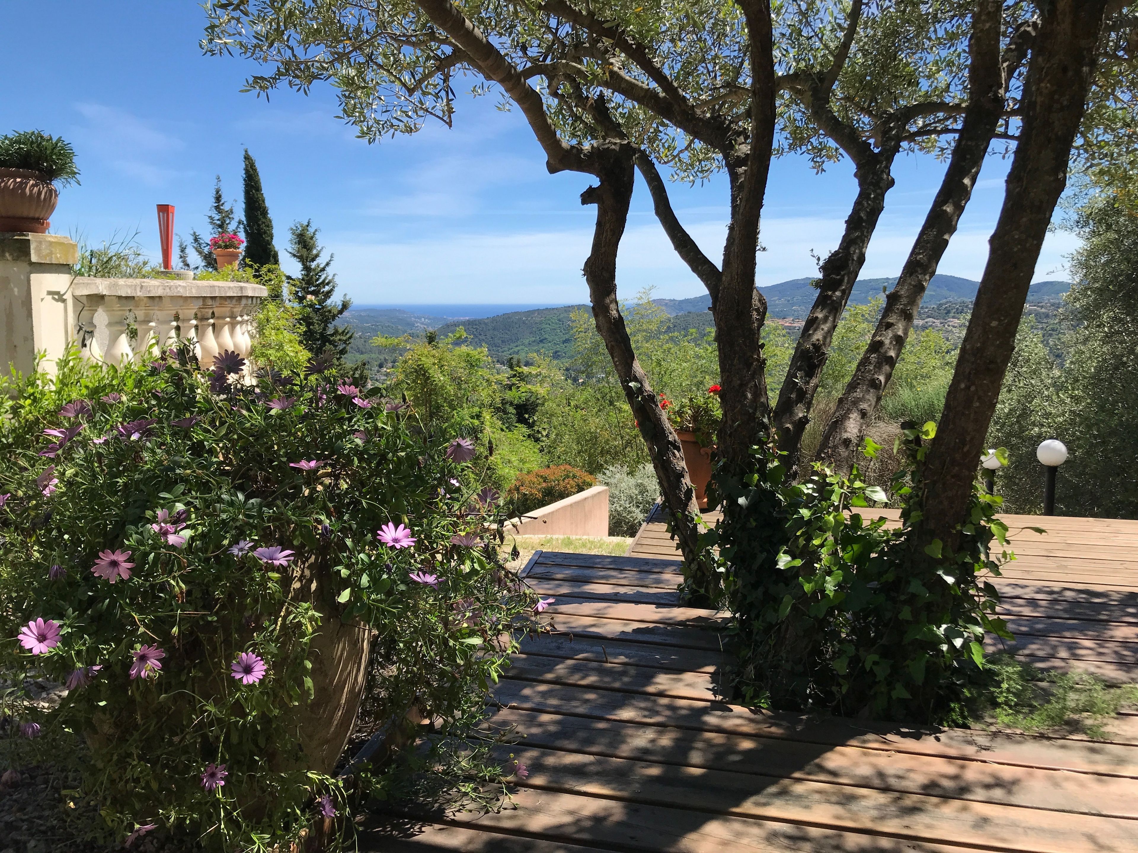 A wooden deck with a view of a mountainous landscape.