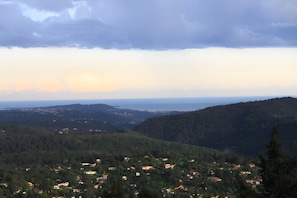 A mountainous landscape with scattered houses and a clear sky.