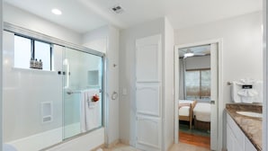 Un bagno moderno con doccia vetrata, un water e un lavabo con piano.