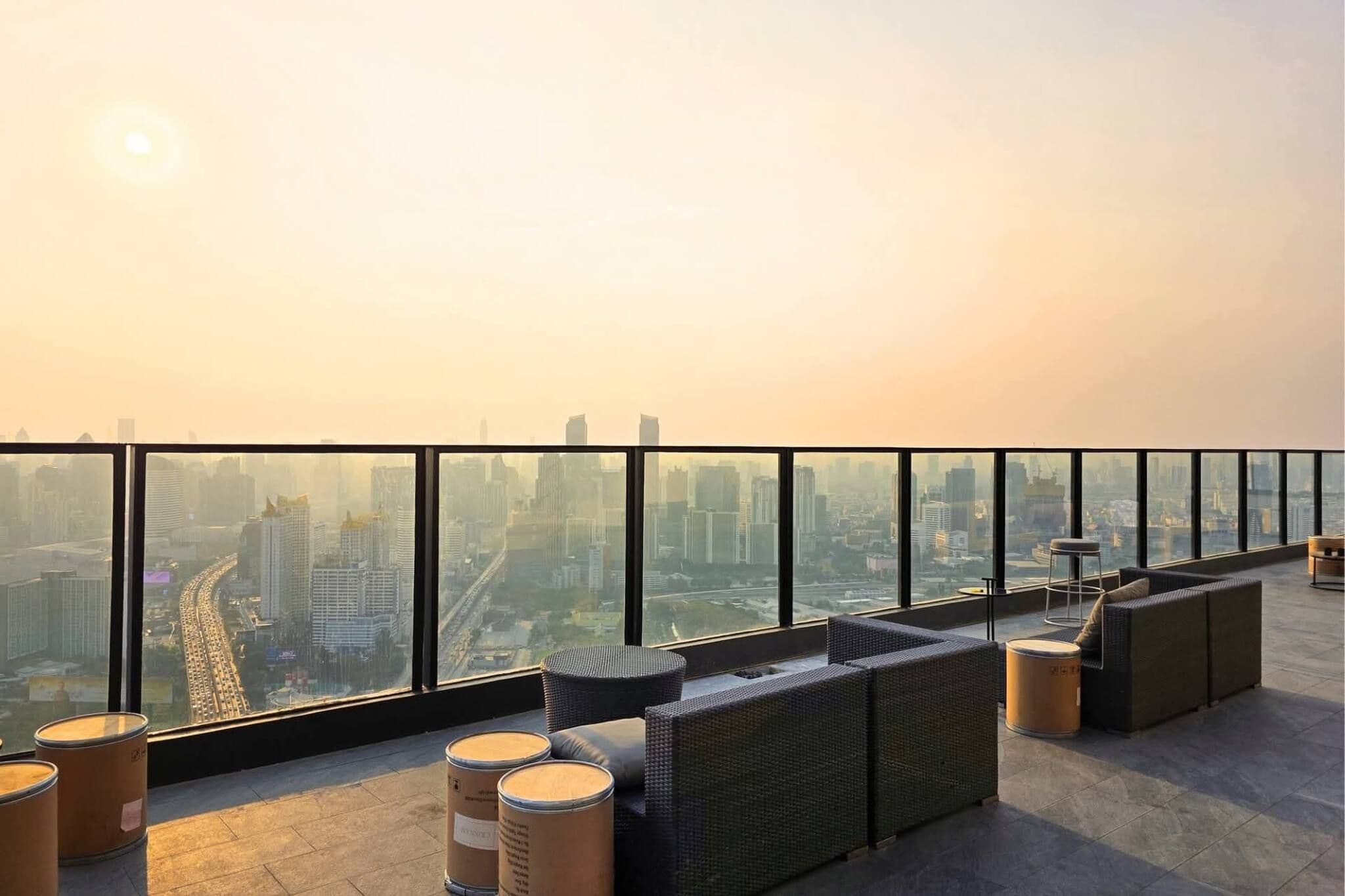 A rooftop terrace with seating and a panoramic city view.