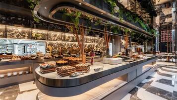A modern buffet setup with a variety of food items and a sleek, curved counter design.