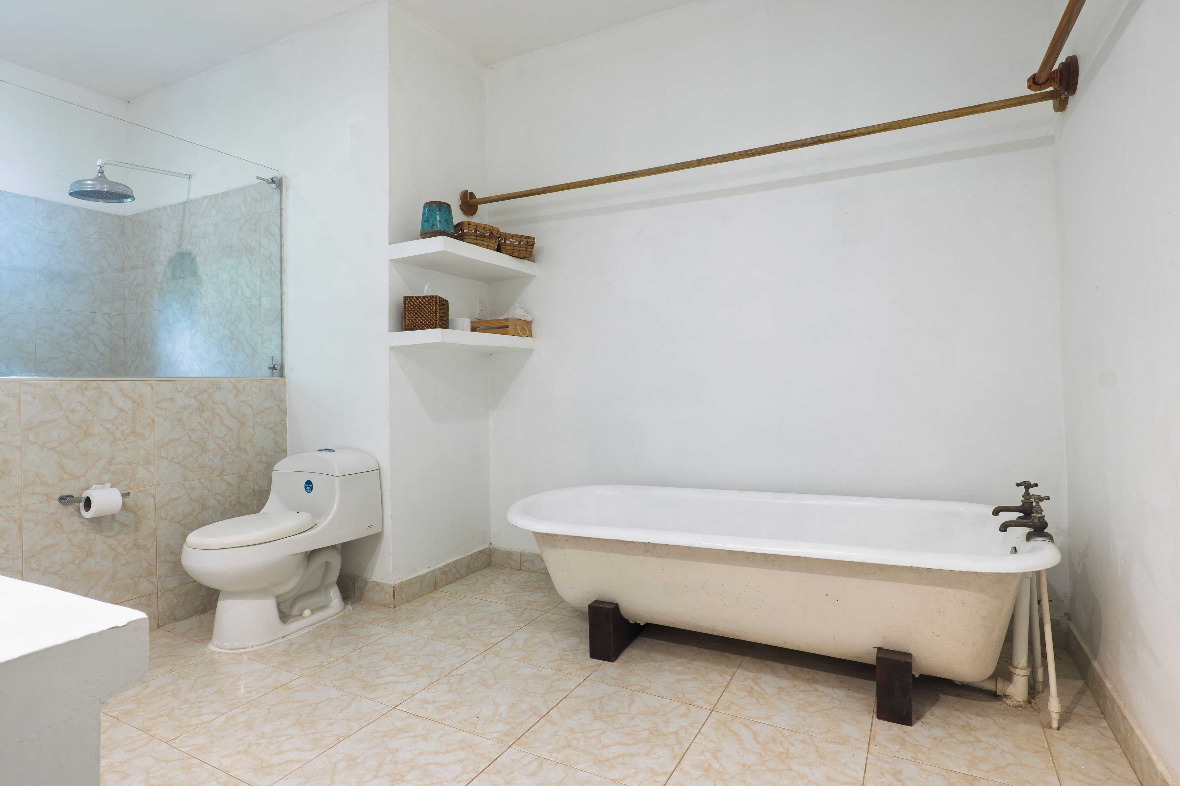 A bathroom with a toilet, a bathtub, and a shower.