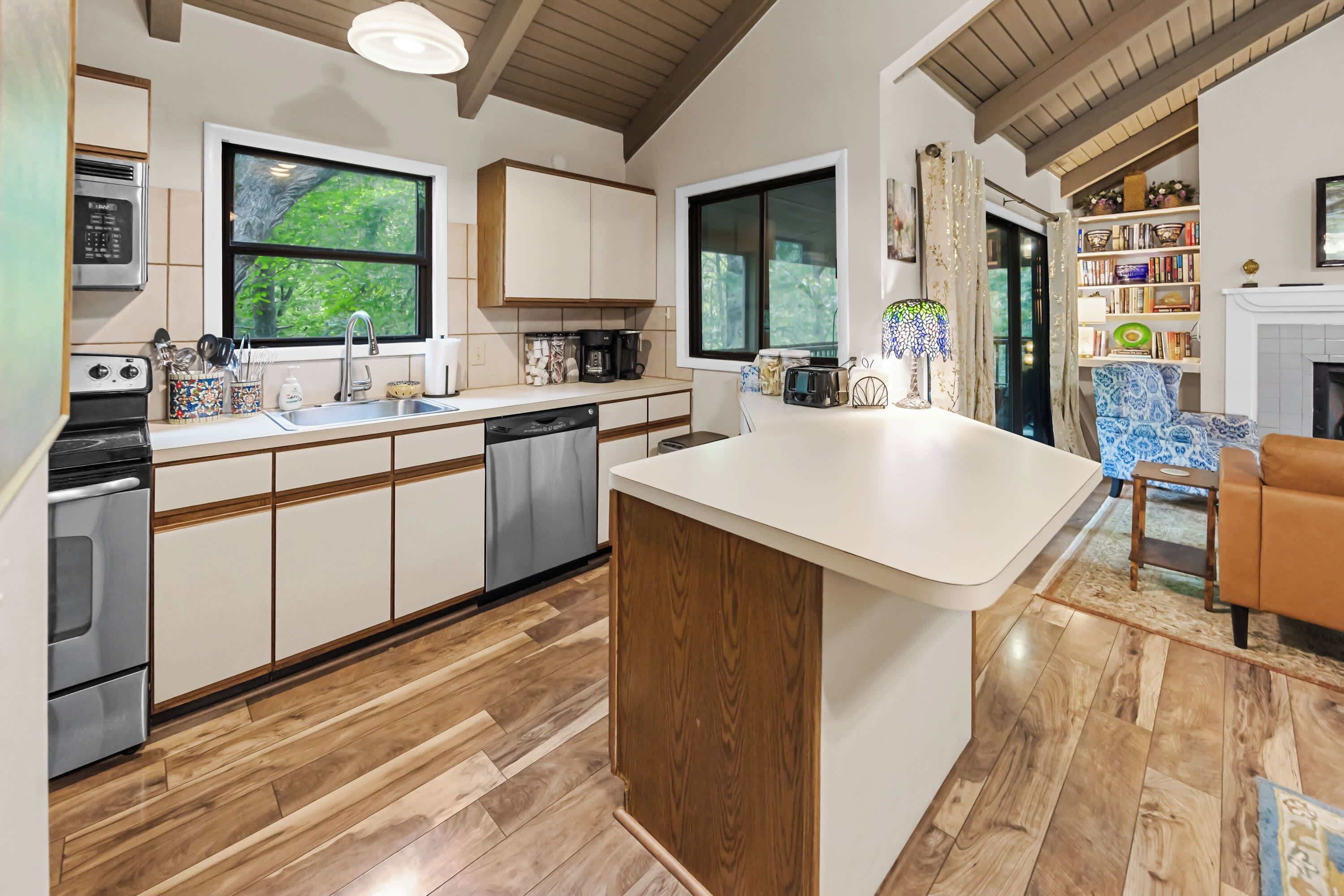 A modern kitchen with wooden cabinets, a dishwasher, and a large island.