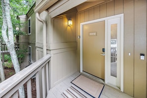 A wooden exterior with a door marked '441 D' and a mailbox.