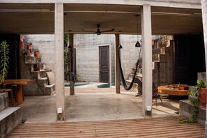 An outdoor patio area with a pool, wooden flooring, concrete pillars, and potted plants. - Marvelous 3-bedroom house in Puerto Escondido near the beach (puerto escondido)