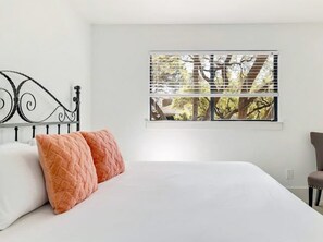 A bedroom with a bed, two pillows, a window with blinds, and a chair. - Lakeside 4BR w Pool, Hot Tub, Dock, B-ball Court (Leander)