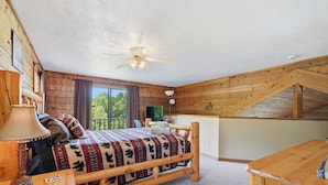 A cozy bedroom with a wooden bed, a desk, and a ceiling fan. - LeVasseur Cabin  Simple Escape (Murphy)