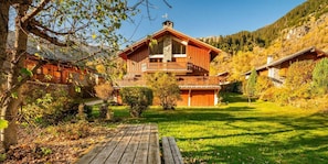 A wooden chalet with a balcony, surrounded by a well-maintained garden and a clear view of the mountains. - Terrace, fireplace or stove, tv, 100m², Champagny-en-Vanoise (Champagny-en-Vanoise)