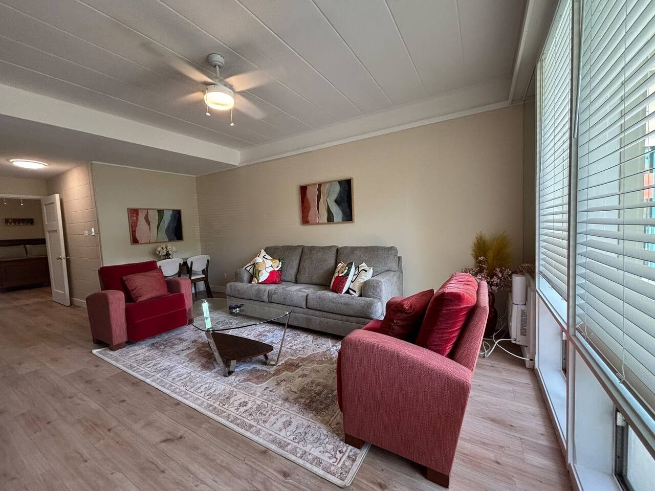 A living room with a sofa set, a coffee table, and a rug.