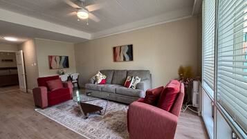 A living room with a sofa set, a coffee table, and a rug.
