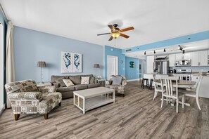 A living room with a sofa set, a coffee table, and a ceiling fan. - Blue View Retreat at Laketown Wharf 720 - Ocean View, 3BR, Gym, Pools, Parking (Panama City Beach)