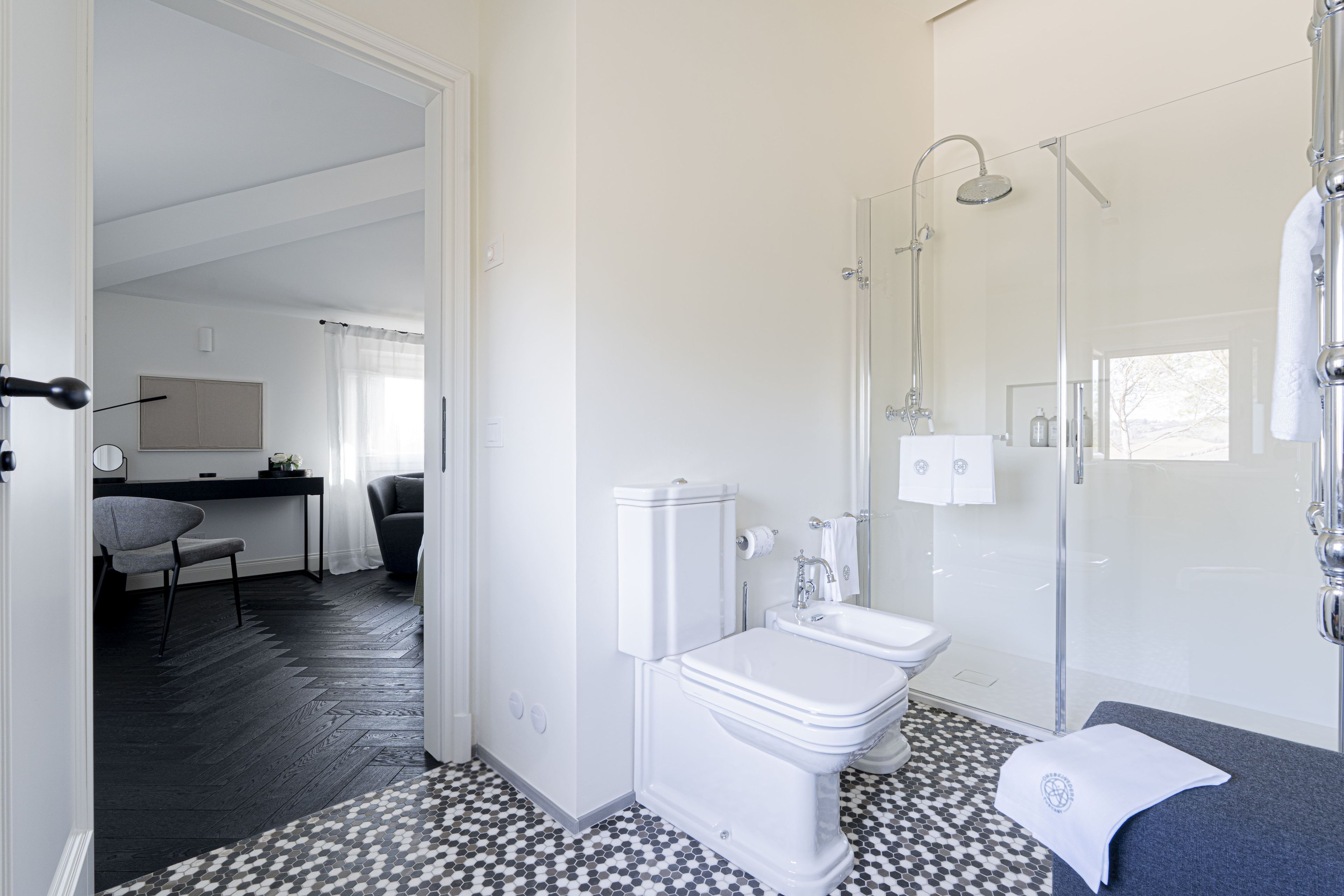 A modern bathroom with a toilet, sink, and shower.