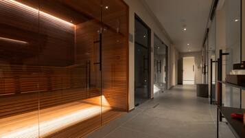 A modern hallway with glass doors, wooden paneling, and a tiled floor.