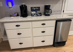 Eine Küche mit Arbeitsplatte, Kaffeemaschine und Geschirrspüler.