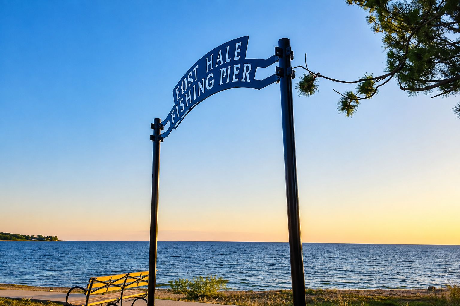 A signpost with 'FIRST HALL FISHING PIER' text, a bench, and a view of the sea.